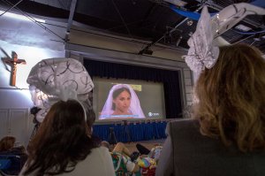 People and students at Immaculate Heart High School and Middle School in Los Angeles gather to view a live broadcast of the wedding of Meghan Markle, who graduated from Immaculate Heart in 1999, to Britain's Prince Harry on May 19, 2018. (Credit: DAVID MCNEW/AFP/Getty Images)
