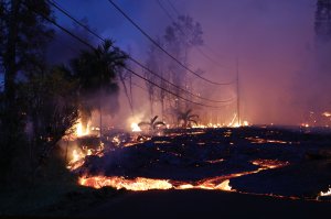 Lava from a Kilauea volcano fissure advances up a residential street in Leilani Estates, in Pahoa on Hawaii's Big Island, May 27, 2018. (Credit: Mario Tama / Getty Images)