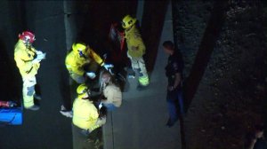 Fire officials speak with a man involved in a fatal single-vehicle crash in Irvine on May 16, 2018. (Credit: KTLA)