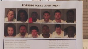 Booking photos of 12 of the suspects are seen at a news conference in Riverside on May 29, 2018. (Credit: KTLA)