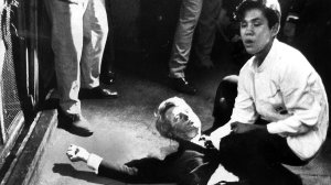 A busboy named Juan Romero crouches over presidential candidate Robert F. Kennedy after the then-senator was fatally shot in Los Angeles just after delivering a victory speech for winning the  California Democratic primary on June 5, 1968. (Credit: Boris Yaro / Los Angeles Times)