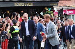 Prince Harry, right, and Prince William meet fans in Windsor on Friday evening. (Credit: Getty Images via CNN)