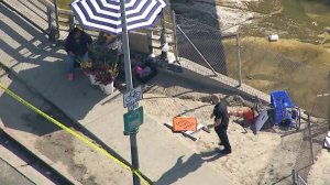 Authorities investigate the scene where a juvenile was stabbed amid an attack on street vendors on May 8, 2018. (Credit: KTLA)