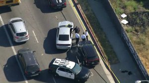 Police investigators survey the scene of a stabbing involving a juvenile in South Los Angeles on May 9, 2018. (Credit: KTLA)