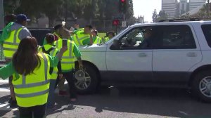 A man drives his vehicle into the crowd as UCLA staff members take part in a statewide strike by University of California service workers on May 7, 2018. (Credit: KTLA)