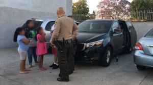 A deputy speaks with the family after the incident in the City of Industry on June 10, 2018. (Credit: Los Angeles County Sheriff's Department) 