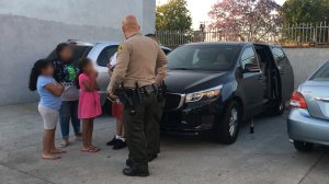 A deputy speaks with the family after the incident in the City of Industry on June 10, 2018. (Credit: Los Angeles County Sheriff's Department)