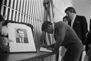 Actor and singer Sammy Davis Jr. is seen signing the book of condolences for Robert Kennedy at the American Embassy, London, June 6, 1968. (Credit: Maher/Daily Express/Hulton Archive/Getty Images)