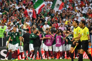 Mexico's defender Hector Moreno (L) and teammates celebrate their 1-0 victory at the end of the Russia 2018 World Cup Group F football match between Germany and Mexico at the Luzhniki Stadium in Moscow on June 17, 2018. (Credit: YURI CORTEZ/AFP/Getty Images)