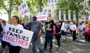 People protest in front of a federal courthouse as Attorney General Jeff Sessions visits Los Angeles on June 26, 2018. (Credit: Frederic J. Brown / AFP / Getty Images)
