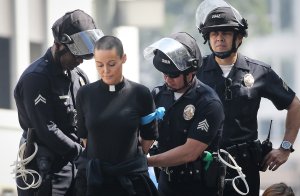 A protestor is arrested during a demonstration over a visit to Los Angeles by Attorney General Jeff Sessions on June 26, 2018. (Credit: Mario Tama / Getty Images)