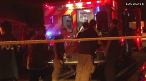 Crews are seen by an ambulance outside a home in Lincoln Heights on June 10, 2018. (Credit: Loudlabs)