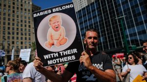 A man holds a poster as he attends the nationwide “Keeping Families Together” march in New York City on June 30, 2018. (Credit: Kena Betancur/Getty Images)