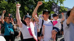 Maia Leung and her family raise their hands as they attend the nationwide “Keeping Families Together” march in New York City on June 30, 2018. (Credit: Kena Betancur/Getty Images)