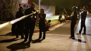 Residents stand outside the police tape after a shooting in North Hollywood on June 10, 2018. (Francine Orr / Los Angeles Times)