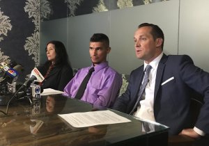 Jose Conde sits between his mother, Rosa Conde, and his attorney, Bret Royle, at a news conference on June 14, 2018, during which he said Mesa police used excessive force during a January arrest. (Credit: Terry Tang/AP via CNN)