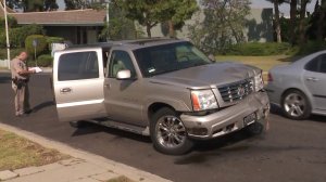 A damaged Cadillac SUV matching the description of one driven by a hit-and-run suspect who intentionally hit a police sergeant was located in Ladera Heights on June 26, 2018. (Credit: KTLA)