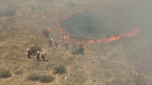 Crews worked to contain a brush fire that was burning in the Stevenson Ranch area on July 23, 2018. (Credit: KTLA)