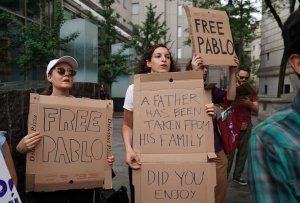 Protesters, with slogans written on pizza delivery boxes, demonstrate outside a federal courthouse in New York on July 24, 2018. (Credit: Timothy A. Clary / AFP / Getty Images)