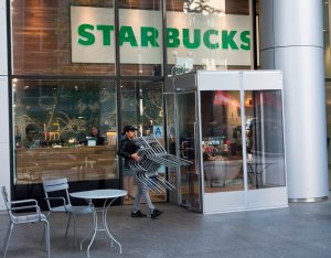 A Starbucks employee puts furniture away on May 29, 2018. (Credit: DON EMMERT/AFP/Getty Images)