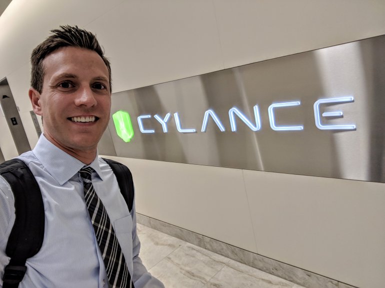 rich demuro in front of a cylance sign