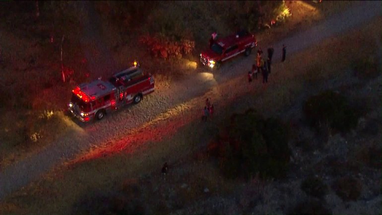 Fire officials respond to the scene where a horse fell on and injured two children in Lake View Terrace on July 10, 2018. (Credit: KTLA)
