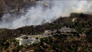 The Griffith Observatory was evacuated as a small brush fire burned precariously close to the historic building on July 10, 2018. (Credit: KTLA)