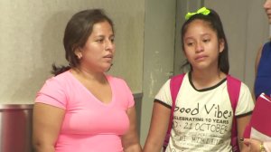 Perla De Velasquez and her daughter, Yoselin, hold hands after a tearful reunion at LAX on July 1, 2018. They had been separated by federal immigration officials for more than a month, according to a lawsuit filed by De Velasquez. (Credit: KTLA)