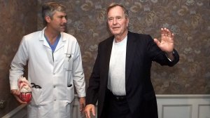 Former President George H.W. Bush, right, and Dr. Mark Hausknecht are seen after a news conference at Houston Methodist Hospital in 2000. (Credit: David J. Phillip / AP via CNN)