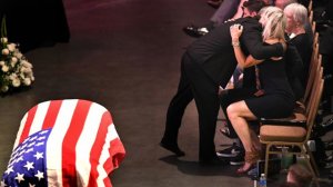 The wife of fallen firefighter Capt. Dave Rosa receives a hug during a memorial service at the Long Beach Convention Center on July 3, 2018. (Credit: Wally Skalij / Los Angeles Times)