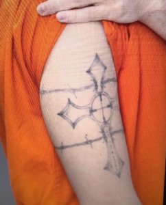 A large tattoo on the right upper arm of Shawn Christy is seen in this undated photo posted to the website for the FBI.