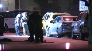 Law enforcement officials investigate a deadly shooting in Colton on Aug. 7, 2018. (Credit: KTLA)