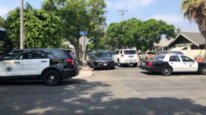 Law enforcement vehicles block a portion of 8th Street in Long Beach due to a barricade situation on Aug. 26, 2018. (Credit: Long Beach Post)
