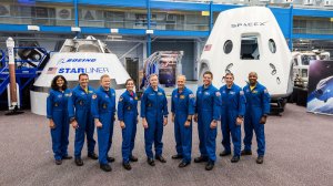 The seven men and two women will also be the first astronauts to fly in capsules developed and built by the private sector are seen in a photo released by NASA.