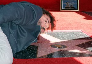 Jack Black pretends to kiss his newly-minted star on the Hollywood Walk of Fame on Sept. 18, 2018. (Credit: David Livingston/Getty Images)