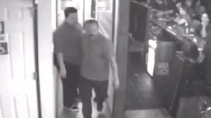 The Covina Police Department is seeking the man pictured in this surveillance camera image, center, who investigators say attacked another man with a beer mug at a Covina bar on Aug. 17, 2018, fracturing the victim's skull.