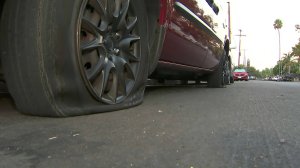 A vehicle with a slashed tire was one of 85 vehicles that were vandalized in Jefferson Park on Sept. 19, 2018. (Credit: KTLA)