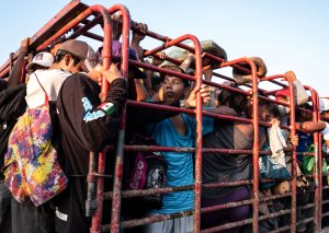 Honduran migrants heading in a caravan to the US, travel on a truck near Pijijiapan, southern Mexico on October 26, 2018. - The Pentagon is expected to deploy about 800 troops to the US-Mexico border, two US officials told AFP on Thursday, after President Donald Trump said the military would help tackle a 'national emergency' and called on a caravan of US-bound migrants to turn around. (Credit: Guillermo Arias/AFP/Getty Images)