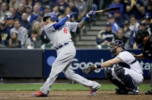 Manny Machado #8 of the Los Angeles Dodgers hits a single against the Milwaukee Brewers during the fourth inning Game Seven of the National League Championship Series at Miller Park on October 20, 2018 in Milwaukee, Wisconsin. (Credit: Jonathan Daniel/Getty Images)