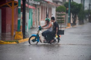 Resident rides their motorcycle as the Hurricane Willa arrives to Escuinapa, Sinaloa state, Mexico, on Oct. 23, 2018. (Credit: Alfredo Estrella / AFP / Getty Images)