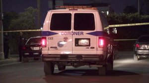 Coroner's officials respond to the scene of a fatal shooting in the Harvard Heights neighborhood of Los Angeles on Oct. 16, 2018. (Credit: KTLA)