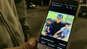 Jason Coffman holds up his phone, showing a photo his 22-year-old son Cody, who died after a gunman opened fire on a bar in Thousand Oaks and killed 12 people on Nov. 7, 2018. (Credit: Kent Nishimura/ Los Angeles Times)