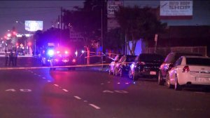 Detectives investigate the fatal shooting of a man at an auto body shop in the 400 block of West Redondo Beach Boulevard in Gardena on Nov. 2, 2018.