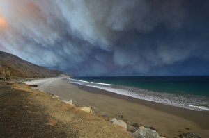 Smoke from the Woolsey Fire blows out over the Pacific Ocean in Malibu on Nov. 9, 2018. (Credit: Robyn Beck / AFP / Getty Images)