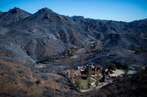 The Santa Monica Mountains near Malibu are seen left blackened by the Woolsey Fire on Nov. 14, 2018. (Credit: David McNew / AFP / Getty Images)