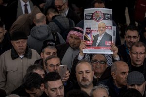 A man holds a poster showing a picture of Jamal Khashoggi after taking part in an absence prayer held after Friday pray at Fatih Mosque on Nov. 16, 2018. (Credit: Chris McGrath / Getty Images)