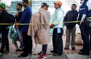 Honduran mother Nubia, center, holds her son Wilmar, 5, as they wait in line for information about applying for asylum in the U.S. on Nov. 23, 2018, in Tijuana, Mexico. (Credit: Mario Tama / Getty Images)