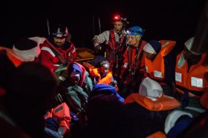 A group of migrants are transferred on Dec. 26 2017, from the Spanish war ship Santa Maria to the non-governmental organization Aquarius ship by SOS Mediterranee and Doctors Without Borders. Some 255 migrants were rescued overnight in the Mediterranean off the coast of Libya, just before a front of bad weather hit the area. (Credit: Federico Scoppa/AFP/Getty Images)