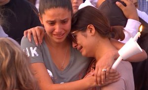 Loved ones of 3-year-old Nathan Luna, who was stabbed to death at his Fontana home on Nov. 1, 2018, mourn the toddler's death during a candlelight vigil the following evening. (Credit: RMG News)
