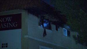 Authorities investigate the scene of a double-fatal shooting and arson fire at a home an apartment in Westchester on Nov. 17, 2018.